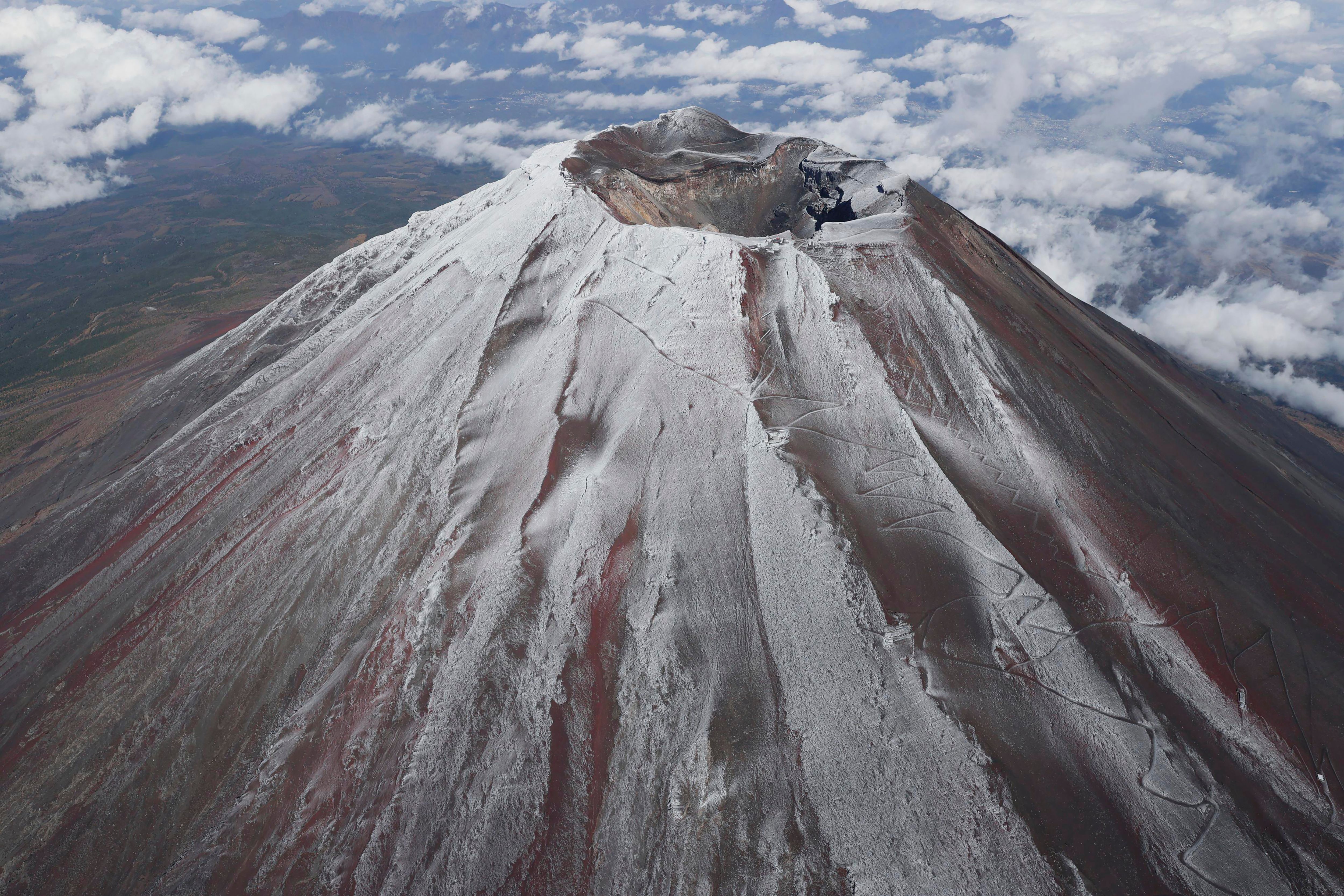 It's not official yet but Mount Fuji gets its trademark snowcap