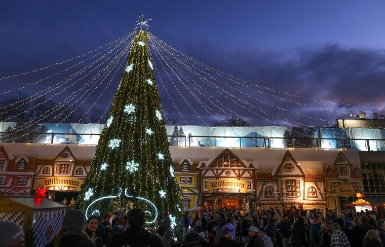 A walk-through Christmas tree adorns the front of the Fisher Pavilion transformed into the Alpen Haus at the Seattle Christmas Market at the Seattle Center on Saturday, December 16, 2023.