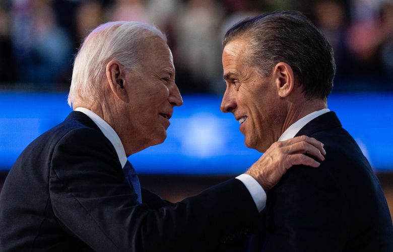 FILE – President Joe Biden embraces his son Hunter Biden after his speech on the first night of the Democratic National Convention in Chicago, Aug. 19, 2024. President Biden issued a full and unconditional pardon of his son Hunter on Sunday, Dec. 1, using the power of his office to wave aside years of legal troubles, including a federal conviction for illegally buying a gun. (Eric Lee/The New York Times) XNYT0197 XNYT0197