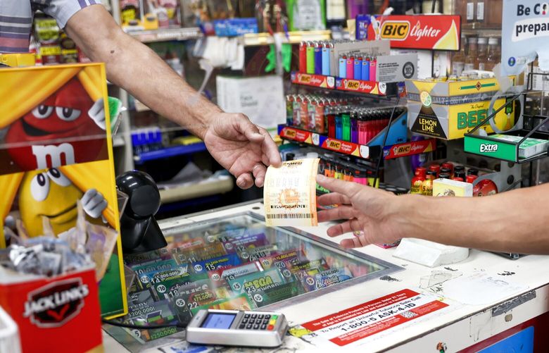 A person buys lottery tickets at Ernies Liquors in San Jose, California, on July 28, 2022. Ernies Liquors is where the 2018 $580 million jackpot ticket was sold. (Shae Hammond/Bay Area News Group/TNS) 128684094W 128684094W