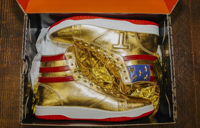 FILE — A pair of signed Trump-branded sneakers bought by Roman Sharf for $9,000; at his office in Southampton, Pa., Feb. 23, 2024. Everything around President-elect Donald Trump has become something to monetize, including a moment of comity with Jill Biden at Notre-Dame over the weekend. (Michelle Gustafson/The New York Times) XNYT0410 XNYT0410