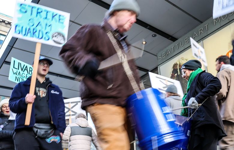 Marcela Soto beats a drum to support the striking Seattle Art Museum Visitor Service Officer (VSO) Union Friday morning in front of the Seattle Art Museum in downtown Seattle,  Washington, on November 30, 2024. 228549