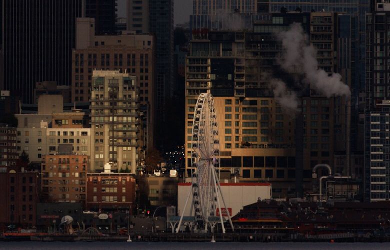 A patch of sun illuminates The Seattle Great Wheel and the Seattle Skyline Thursday, Nov. 14, 2024. 
 228531