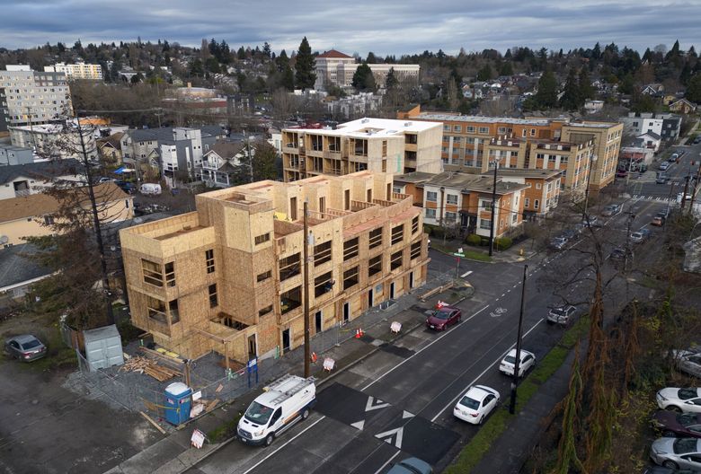 Thousands of units in multifamily buildings are under construction in Seattle, including in this one going up near Renton Place South and South Walden Street in Seattle. Franklin High School is at top center.  (Ellen M. Banner / The Seattle Times)