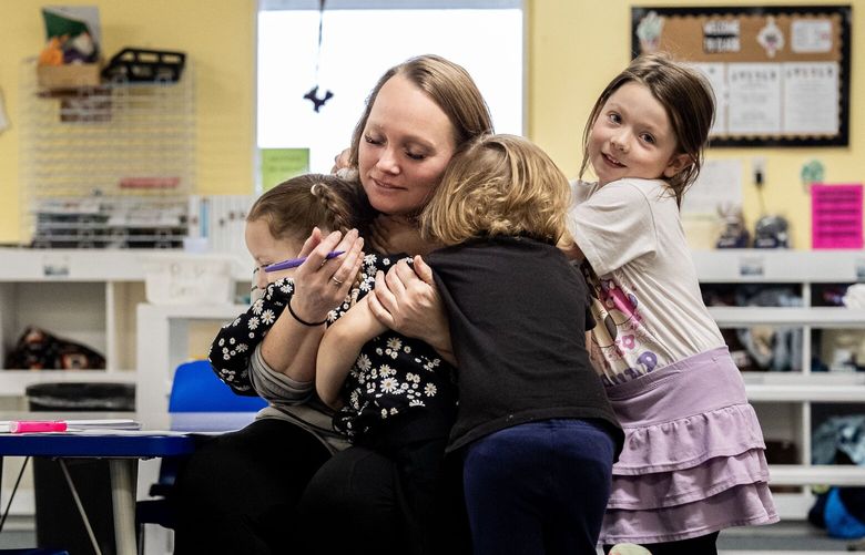 Krystal McFarlane, the director of TLC for Tots day care in Nampa, Idaho, gets sustained hugs from several of the preschool children. MUST CREDIT: Melina Mara/The Washington Post