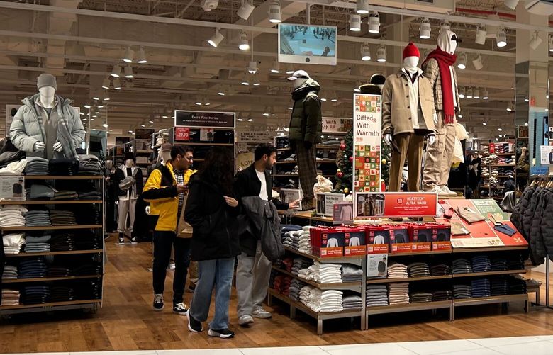 The Federal Reserve lowered its key interest rate by a quarter point on Wednesday, which means the rates consumers pay on credit cards, home equity lines of credit and other loans should fall in a similar fashion. Shoppers look at items displayed at a Uniqlo store at the Newport Centre mall on Dec.15, 2024, in Jersey City. N.J. (AP Photo/Anne D’Innocenzio) 
