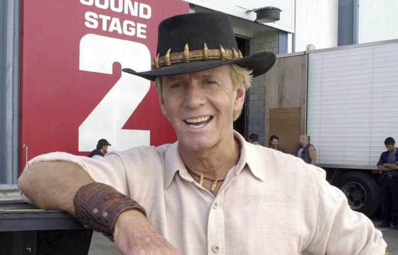 FILE – Actor Paul Hogan stands on the set of “Crocodile Dundee in Los Angeles” on the Gold Coast, Australia Tuesday Aug. 29, 2000. (AP Photo/Steve Holland, File) ny797 ny797