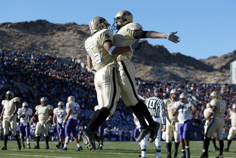 Purdue&#8217;s Joey Harris (25) leaps into the chest of an unidentified teammate after scoring a third quarter rushing touchdown against Washington.(Dean Rutz / The Seattle Times, 2002)