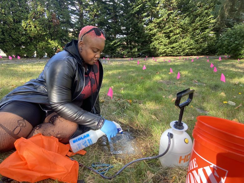 Patrice Horton, visiting the Seattle area from Chicago, stopped by the cemetery in the fall to help clean graves. She heard about the event at a Seattle-area death care conference, held in September. (Elise Takahama / The Seattle Times)