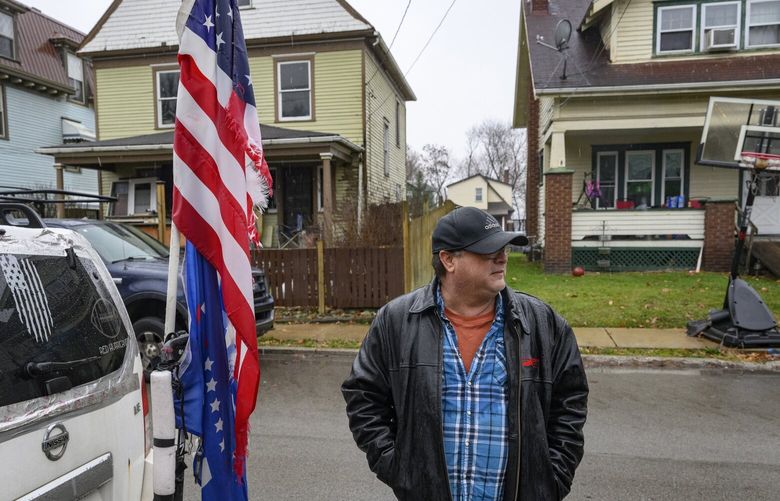 Steve Tillia shows off his Trump flag in front of his New Castle home. MUST CREDIT: Jeff Swensen for The Washington Post