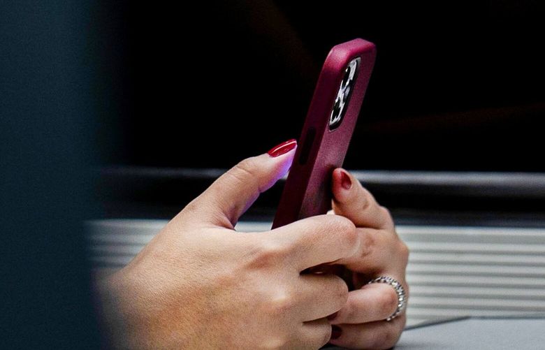 Cellphone use on an Amtrak train. (AP Photo/Jenny Kane, 2021)