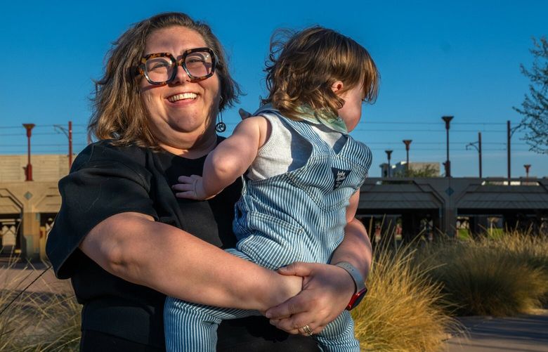 Xanthia Walker with her child Archimedes at Hance Park near her work in downtown Phoenix, Dec. 6, 2024. Walker started going to the doctor more regularly when she found a physician who rejected the “weight-centric” model of medicine. (Ash Ponders/The New York Times) XNYT0297