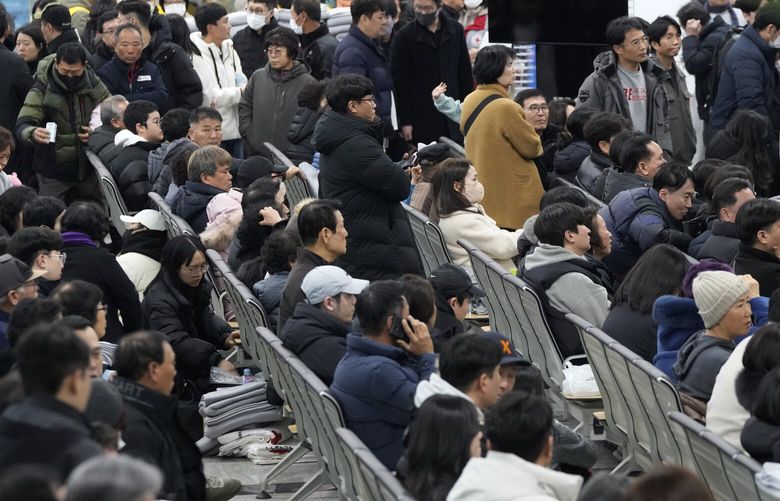 Relatives of passengers gather at Muan International Airport in Muan, South Korea, Sunday, Dec. 29, 2024, after a passenger plane crashed at the airport. (AP Photo/Ahn Young-joon) SEL116 SEL116