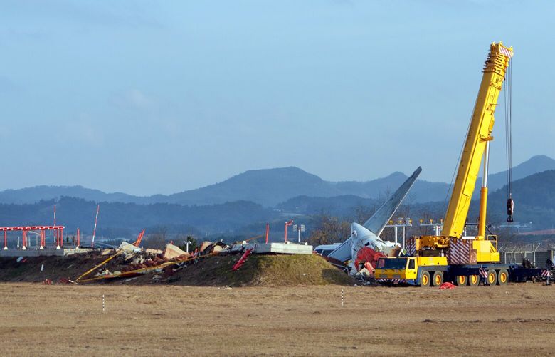 The scene on Monday, Dec. 30, 2024 at the end of the runway where Jeju Air Flight 7C2216 burst into flames the day before at Muan International Airport in Muan, South Korea. Aviation safety analysts said they expect officials investigating the crash, which killed 179 people, to look into the location and composition of a structure housing an antenna. (Chang W. Lee/The New York Times) XNYT0795 XNYT0795