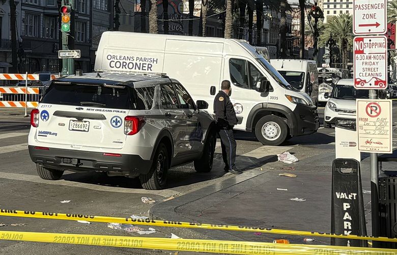 A coroner’s van is parked on the corner of Bourbon St. and Canal St, after a vehicle raced into a crowd of revelers early on New Year’s Day, in New Orleans on Wednesday, Jan. 1, 2025. (AP Photo/Jack Brook) RPJB101 RPJB101