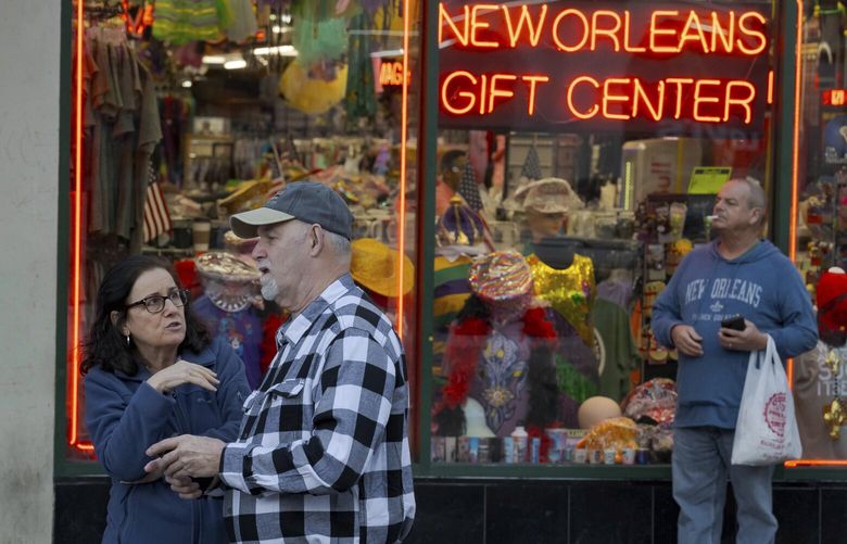 People react at the intersection of Bourbon Street and Canal Street during the investigation after a pickup truck rammed into a crowd of revelers early on New Year’s Day, Wednesday, Jan. 1, 2025, in New Orleans. (AP Photo/Matthew Hinton) LAMH165 LAMH165
