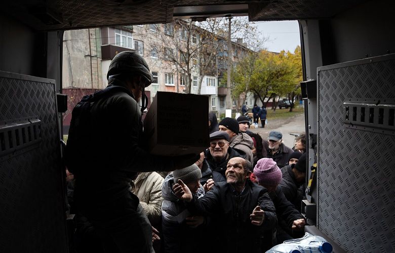 FILE — Ukrainian civilians receive humanitarian aid in the embattled city of Myrnohrad, Ukraine, Nov. 7, 2024. As President-elect Donald J. Trump prepares to take office, questions about sanctions — and future — are expected to come under renewed scrutiny. (Tyler Hicks/The New York Times)