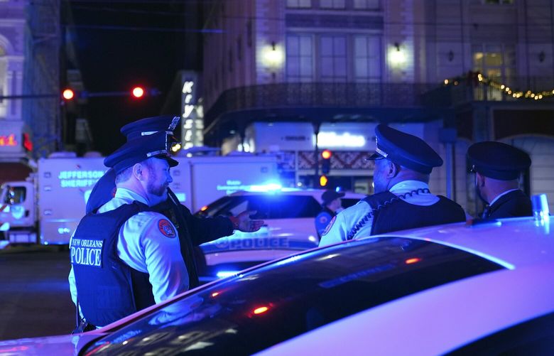Police officers stand near the scene where a vehicle drove into a crowd on New Orleans’ Canal and Bourbon streets, Wednesday, Jan. 1, 2025. (AP Photo/George Walker IV) NYSS109 NYSS109
