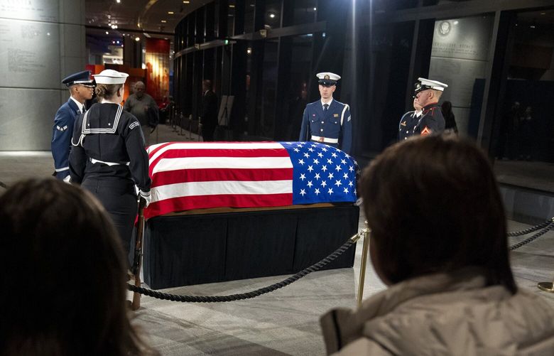 Mourners view the casket of former President Jimmy Carter as he lies in repose at the Jimmy Carter Presidential Library and Museum in Atlanta, Sunday, Jan. 5, 2025. Carter died Dec. 29, 2024, at the age of 100. (AP Photo/Alex Brandon, Pool) GAAB331 GAAB331