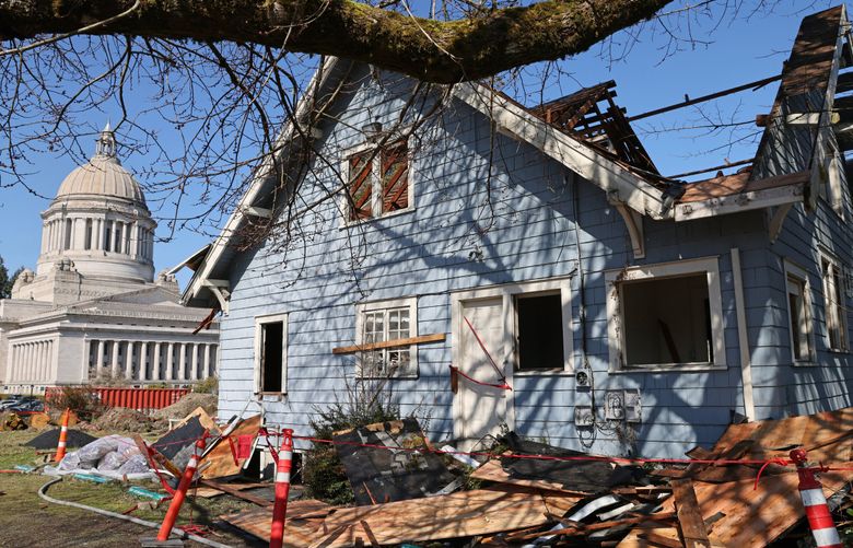 The Carlyon House, also known as the Blue House, during its deconstruction by the Hoffman Construction Company in Olympia, Washington, on Wednesday, March 22, 2023. Its deconstruction is part of the Legislative Campus Modernization (LCM) project to replace and renovate aging buildings on the West Capitol Campus. The house was occupied by members of the Capitol Press Corps between the early 1980s and 2021. The Capitol Press Corps moved into new space in the Legislative Building earlier this year. DES is taking steps to offset the loss of those historic buildings through a process called historic mitigation. Salvage, starting with the roof, is the first step in deconstruction.

 (Karen Ducey / The Seattle Times)