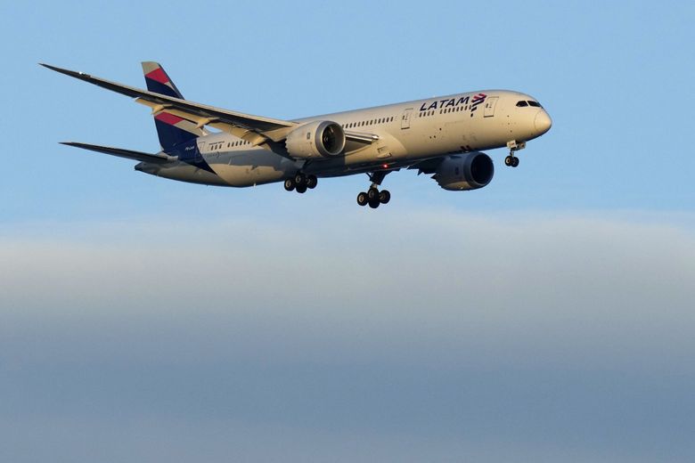 A LATAM Airlines Boeing 787 approaches for landing in Lisbon at sunrise on July 5, 2023. (Armando Franca / The Associated Press)