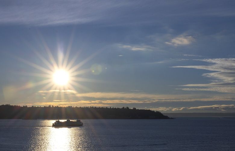 A Washington State ferry heads out from the Seattle Ferry Terminal at Colman Dock in Seattle on Wednesday, as seen from Pike Place Market. Sunny skies should be around for most of next week. (Ellen Banner / The Seattle Times)