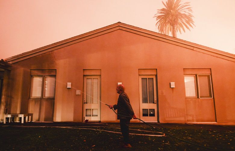 A resident sprays water outside the fire-stricken Pacific Palisades Presbyterian Church in Pacific Palisades, California, Jan. 7, 2025. President-elect Donald Trump blamed California’s Democratic governor on Wednesday for the failure to contain fires engulfing parts of the Los Angeles area, accusing the state’s government of letting environmental policies run amok. (Mark Abramson/The New York Times) XNYT0365