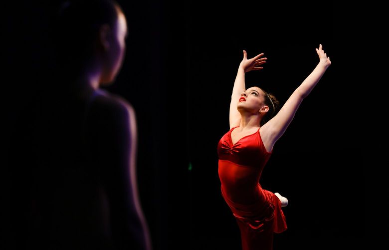 Keagan Tully-Rupert, 13, left, standing backstage, watches Chloe Drew, 13, perform at the Youth America Grand Prix 2025 Season Semi-Finals at the Edmonds Center for the Arts in Edmonds on January 9, 2025.  Hundreds of aspiring ballet dancers ages 9 to 19 from Washington and BC, Canada audition for spots in hopes of receiving scholarships to top ballet schools and companies worldwide. The auditions run between January 8 – 12.