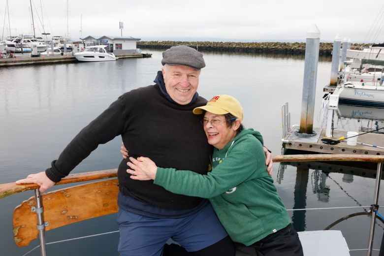 Teresa Wagner and Eric Bischoff on their home – a 67-foot-long Ed Monk power boat – at Shilshole Bay Marina. Their coffee shop, Jibe Espresso Bar, is a neighborhood hangout. (Karen Ducey / The Seattle Times)