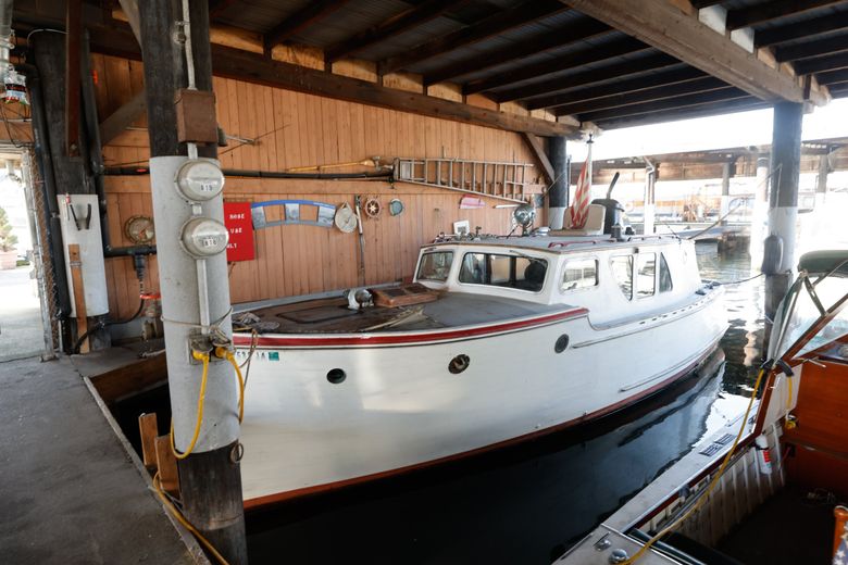 Ryan Currier lives on the Elwood, a 1940 Ed Monk wooden sedan cruiser he bought for $10,000 in the early 2000s. (Karen Ducey / The Seattle Times)