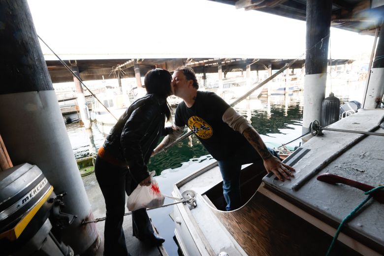 Ryan Currier says goodbye to his girlfriend, Liberty Bordeaux, at Sagstad Marina in Ballard. (Karen Ducey / The Seattle Times)