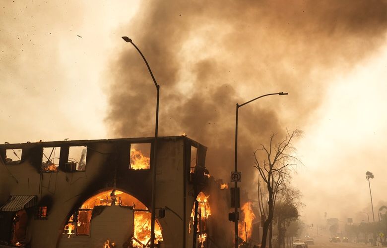 FILE – A structure on Lake Avenue is engulfed in flames, Jan. 8, 2025, in the Altadena section of Pasadena, Calif. (AP Photo/Chris Pizzello, File) CLI402 CLI402