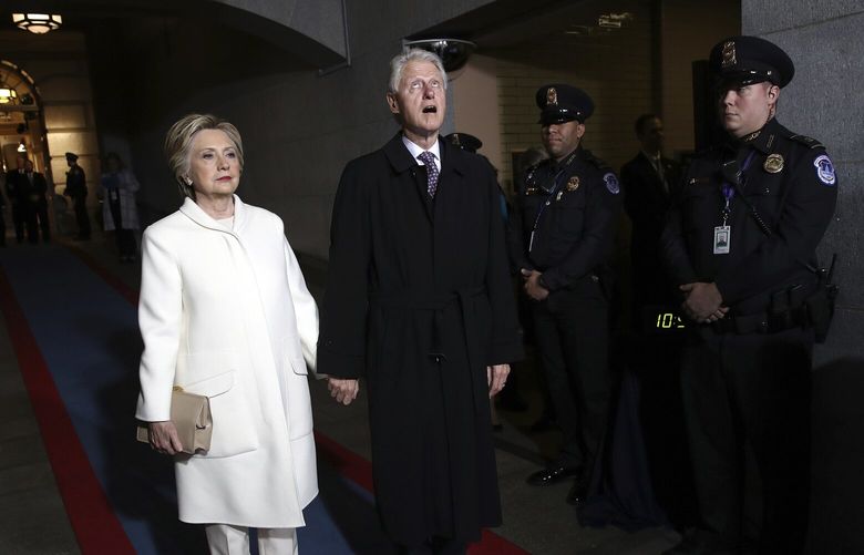 FILE – Former Sen. Hillary Clinton and former President Bill Clinton arrive on the West Front of the U.S. Capitol, in Washington, Jan. 20, 2017, for the inauguration ceremony of Donald J. Trump as the 45th president of the United States. (Win McNamee/AP Photo File) XAB305 XAB305