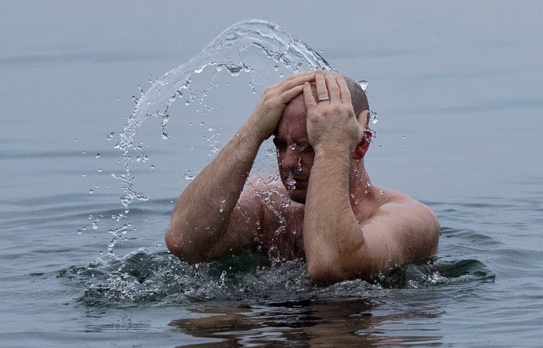 Zeek Earl douses himself with the frigid water of Shilshole Bay on Wednesday, Jan. 15, 2025, in Seattle.
