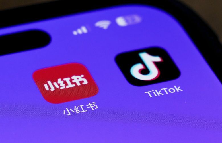 Icons for the smartphone apps Xiaohongshu and TikTok are seen on a smartphone screen in Beijing, Tuesday, Jan. 14, 2025. (AP Photo/Andy Wong) XAW112 XAW112