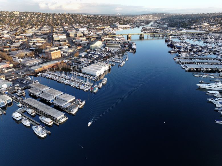 On a clear winter day, Sagstad Marina, at left front, and neighboring Ballard Mill Marina sit along the Lake Washington Ship Canal looking east toward the Ballard Bridge. (Karen Ducey / The Seattle Times)