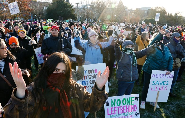 People react to speakers at a rally called The People’s March at Cal Anderson Park in Seattle on Saturday, January 17, 2025. The event aims to unite the community in a collective stand for justice, equality, and human rights.