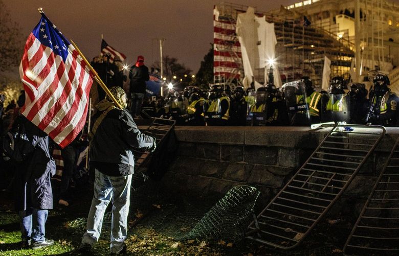 FILE – Rioters face off with police on the Capitol grounds in Washington on the evening of Jan. 6, 2021, after storming the building. When inmates are released from federal prison, the Justice Department places a call to their victims, notifying them that the defendant who attacked them is now free. On Jan. 21, 2025, the phones of U.S. Capitol Police and D.C. police officers were buzzing nonstop. (Jason Andrew/The New York Times) XNYT0236 XNYT0236