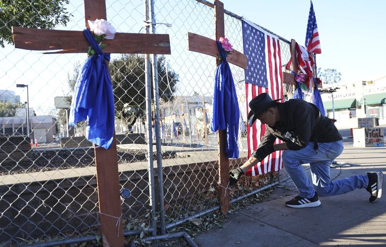 Roberto Marquez, of Dallas, Texas, secures a cross at a memorial he built for fire victims at Lake Avenue and Villa Street in Pasadena, Calif., on Wednesday, Jan. 15, 2025. (Scott Strazzante/San Francisco Chronicle via AP) CAFRA
