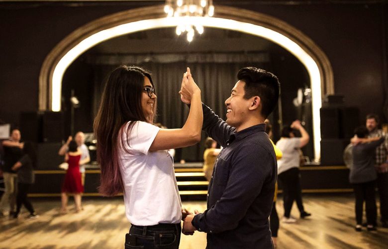 Dancers attend a salsa class at The Century Ballroom. Hallie Kuperman, owner of Century Ballroom, says the business is rooted in creating connections with one another and helping people be “good lead and follows.” 210283
