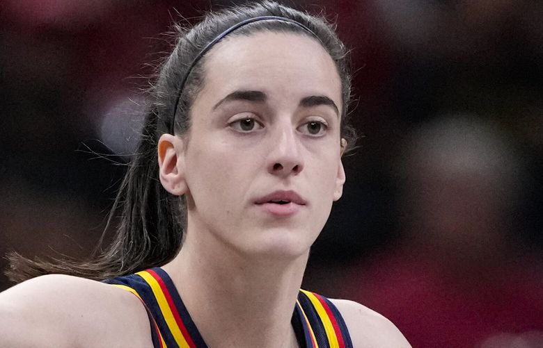 FILE – Indiana Fever guard Caitlin Clark (22) play sagainst the Washington Mystics in the first half of a WNBA basketball game in Indianapolis, Wednesday, July 10, 2024.  (AP Photo/Michael Conroy, File)