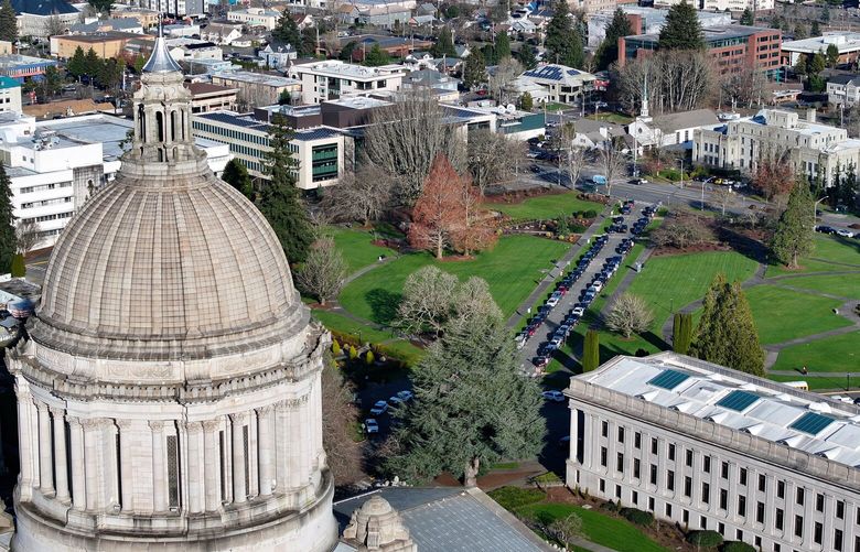 The dome of the Washington state Capitol building with the city of Olympia in the dsistance, on Wednesday, January 22, 2025.