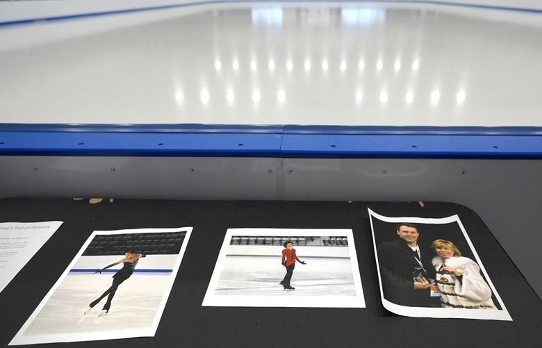 Photographs of aircraft crash victims from The Skating Club of Boston rink are displayed rink side, Thursday, Jan. 30, 2025, in Norwood, Mass. From left is skater Jinna Han, skater Spencer Lane and coaches Vadim Naumov and Evgenia Shishkova. (AP Photo/Charles Krupa) MACK102 MACK102
