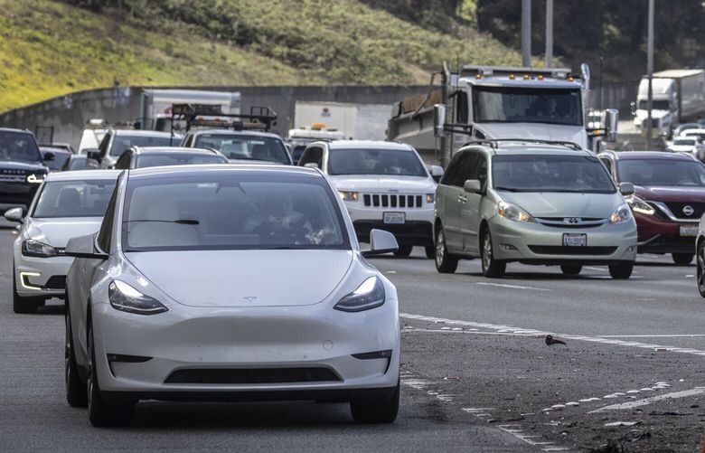 Thursday, March 31, 2022.      Cars leaving the Seattle downtown heading north on I-5 including this Tesla at left.   The story is about Washington’s goal to phase out sales of gas-powered cars by 2030. Some concerns include cost; availability of charging stations; etc. 220007