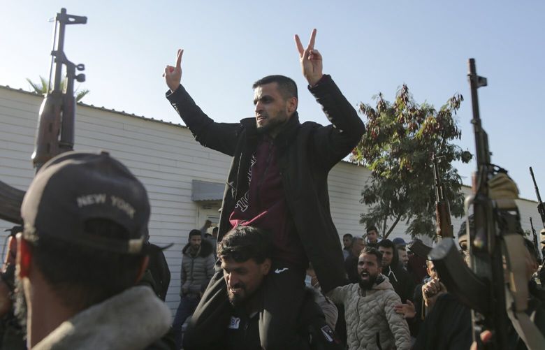 A freed Palestinian prisoner, center, is greeted by a crowd as he arrives in the Gaza Strip after being released from an Israeli prison following a ceasefire agreement between Hamas and Israel in Khan Younis, Saturday, Feb. 1, 2025. (AP Photo/Jehad Alshrafi) FS202 FS202
