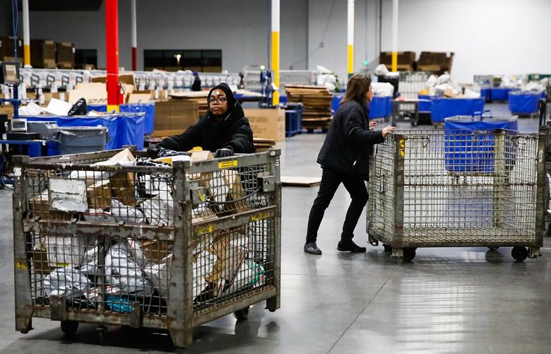 USPS employees sort packages at a distribution center on Dec. 13, 2023, in Henderson, Nevada. (Daniel Pearson/Las Vegas Review-Journal/TNS) 134042725W 134042725W