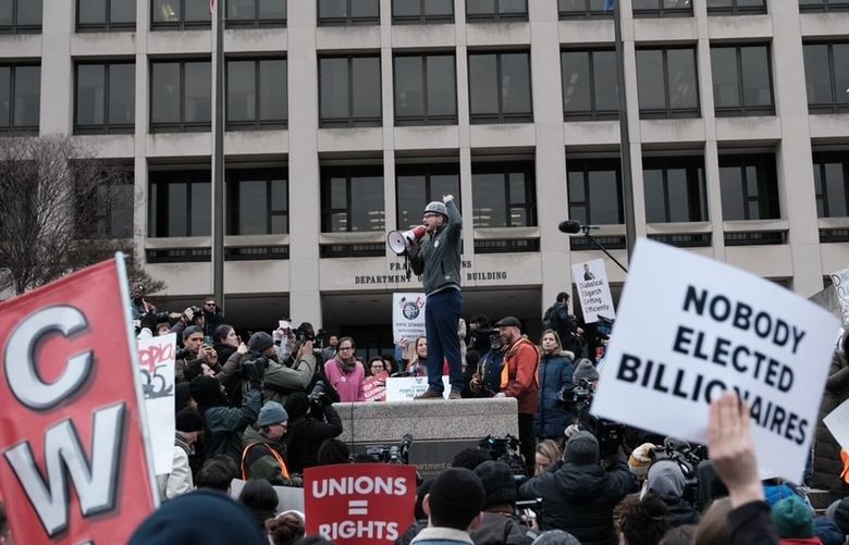 Demonstrators gather outside the Labor Department headquarters Wednesday. (MUST CREDIT: Michael A. McCoy for The Washington Post)