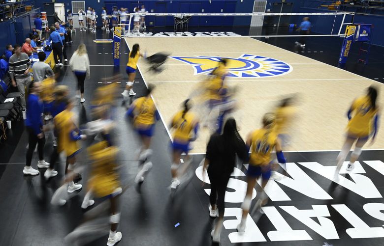 FILE -The San Jose State players take the court for warm ups before an NCAA women’s college volleyball match against Air Force, Thursday, Oct. 31, 2024, in San Jose, Calif. (AP Photo/Eakin Howard, File) NYDD240 NYDD240