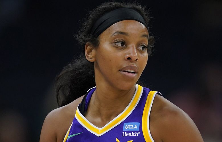 Los Angeles Sparks guard Lexie Brown dribbles down the court during the first half of a WNBA basketball game against the Minnesota Lynx Sunday, June 11, 2023, in Minneapolis. (AP Photo/Abbie Parr)