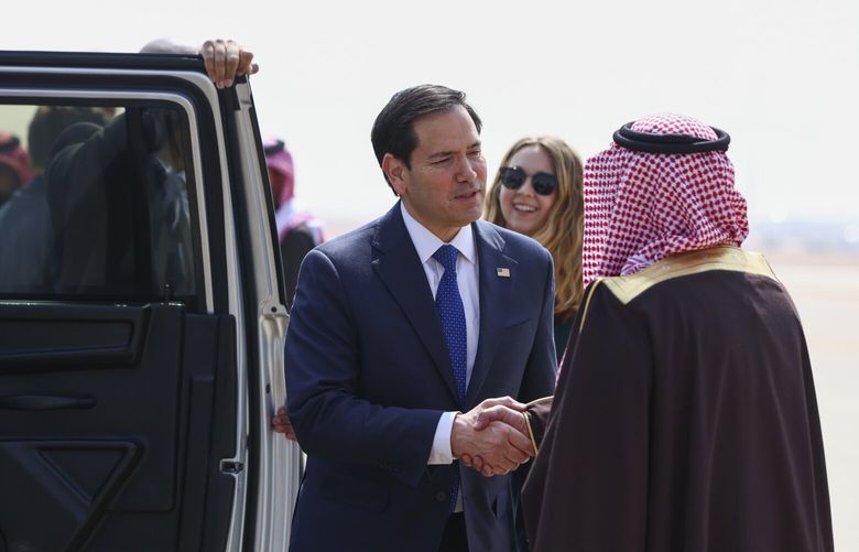 U.S. Secretary of State Marco Rubio shakes hands with Saudi Arabia’s Deputy Minister for Protocol Affairs Abdulmajeed Al-Smari, right, as he arrives at King Khalid International Airport in Riyadh, Saudi Arabia, Monday Feb. 17, 2025. (Evelyn Hockstein/Pool Photo via AP) elm105 elm105